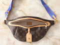 The Blue Breeze Bum Bag is your new go‑to luxury‑inspired crossbody for everyday wear. Featuring premium monogram canvas and a bold blue adjustable strap, this stylish belt bag keeps your essentials secure while adding a pop of color to any outfit. Perfect for travel, errands, and hands‑free days, the Blue Breeze delivers comfort, convenience, and effortless street‑chic style.
