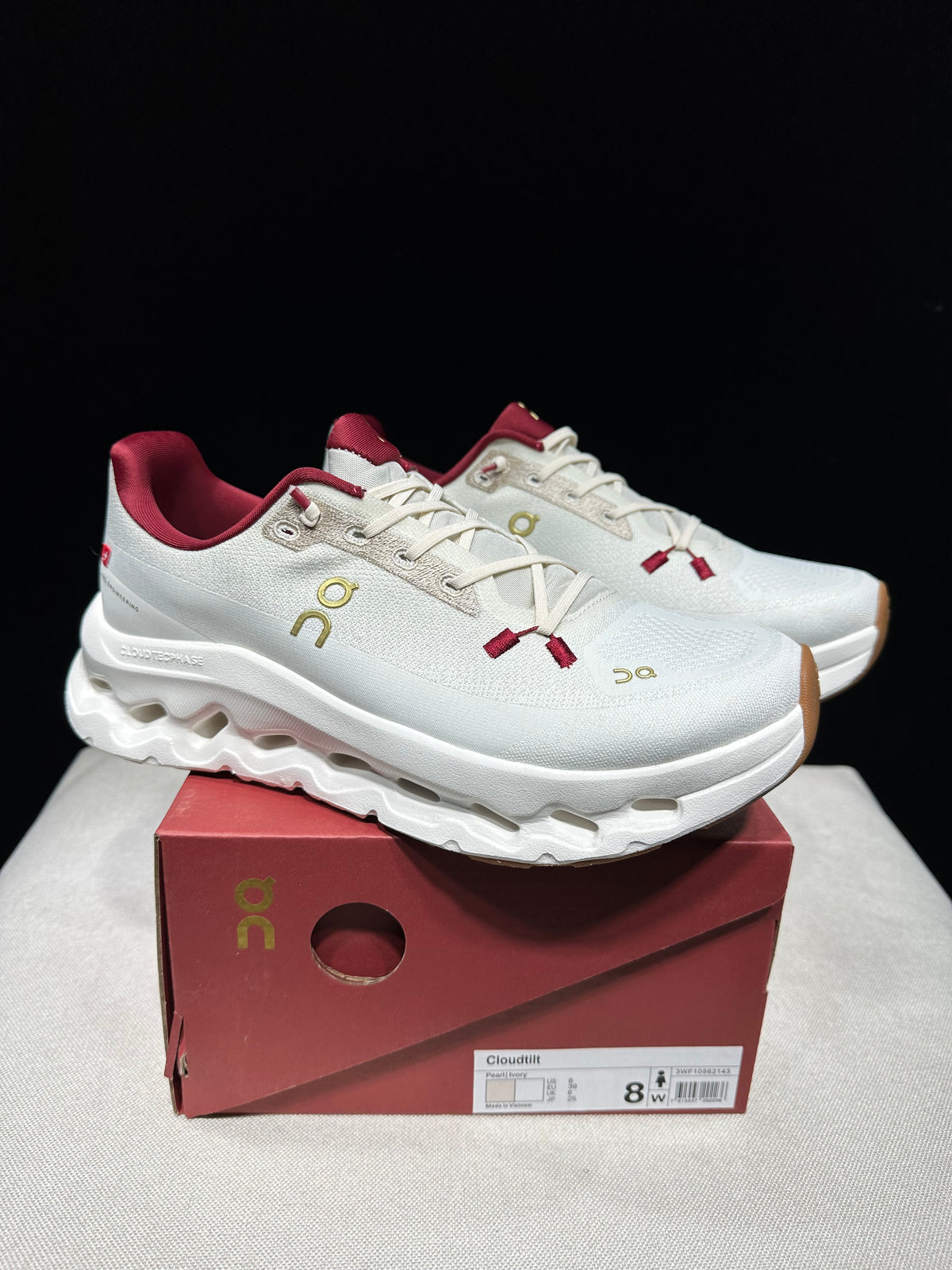 White with burgundy and gold accents.